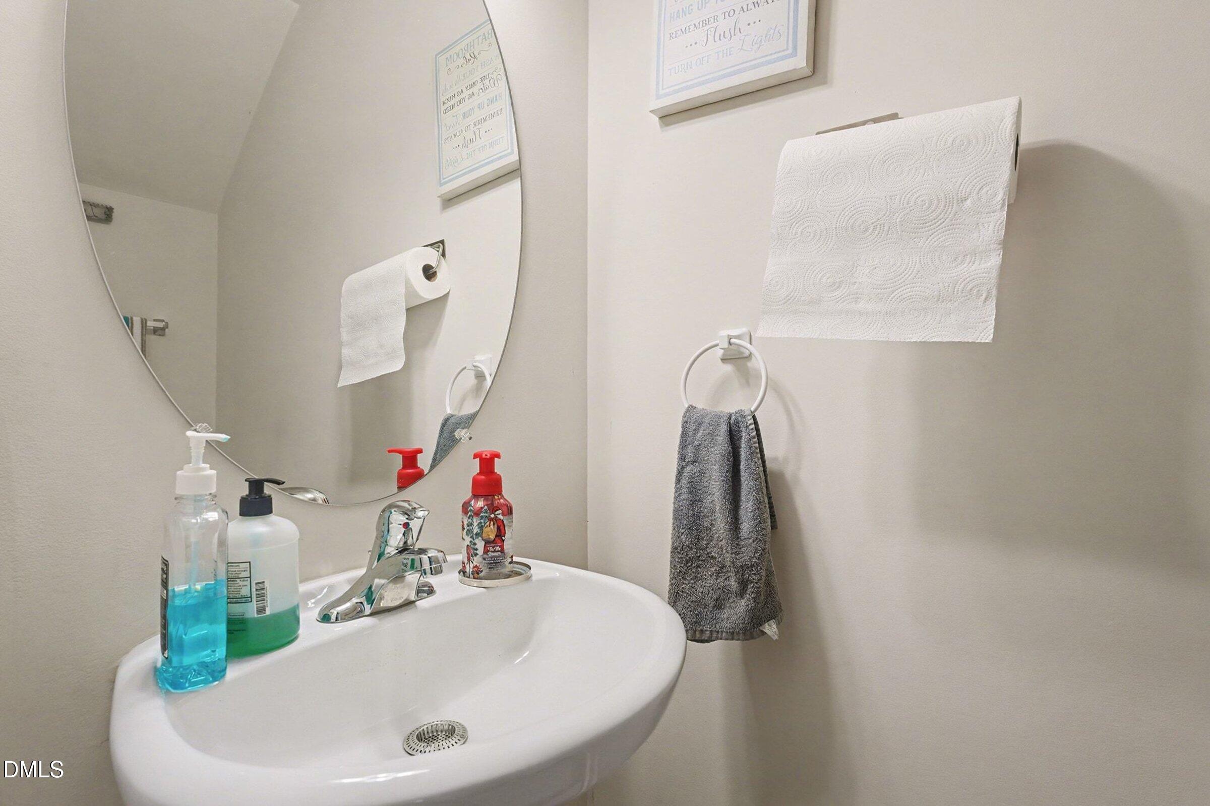 1404 Ricochet Drive Raleigh, NC 27610 - Photo 14 of 31 a bathroom with a sink and mirror
