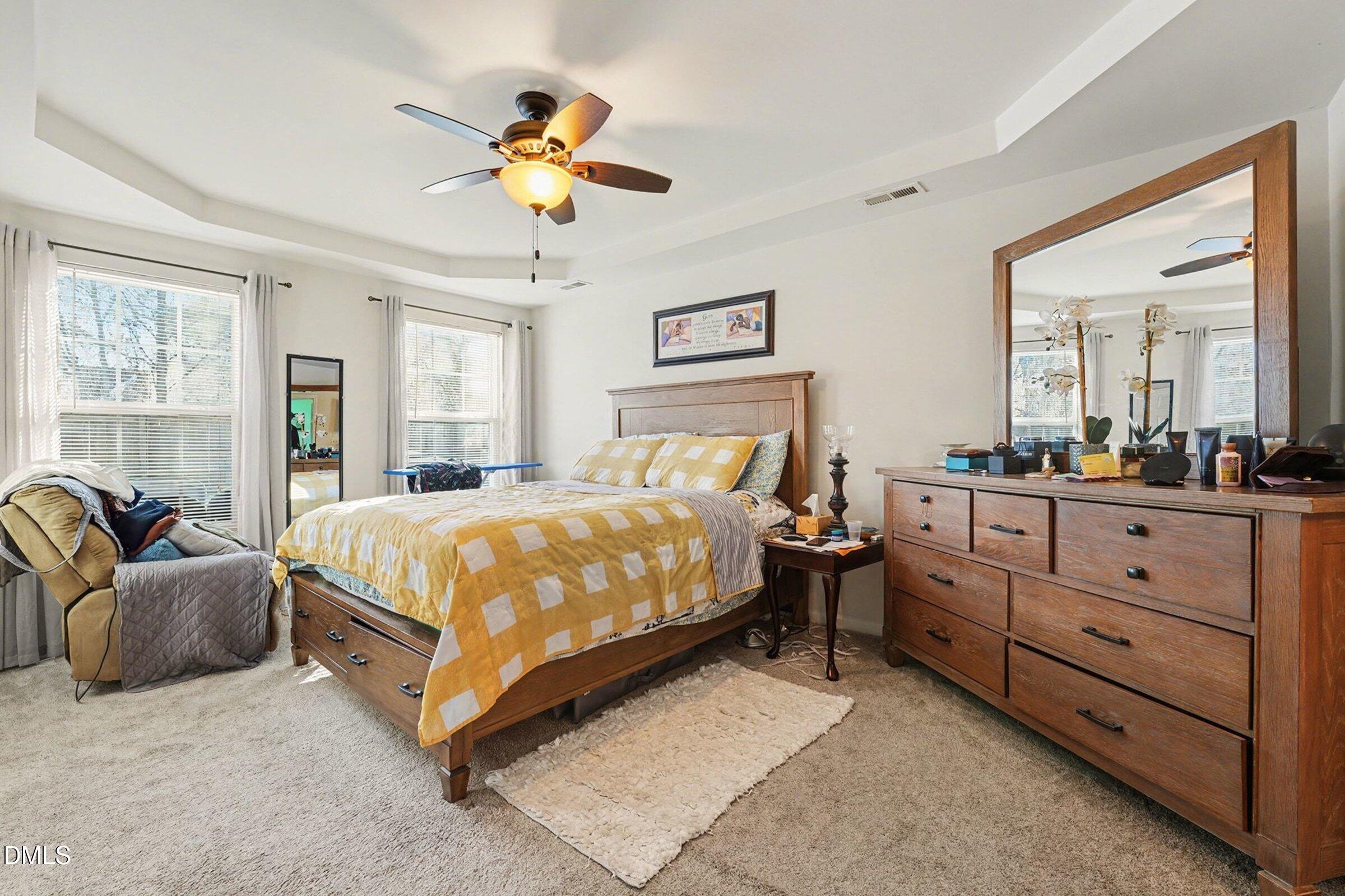 1404 Ricochet Drive Raleigh, NC 27610 - Photo 15 of 31 a bedroom with a bed and ceiling fan