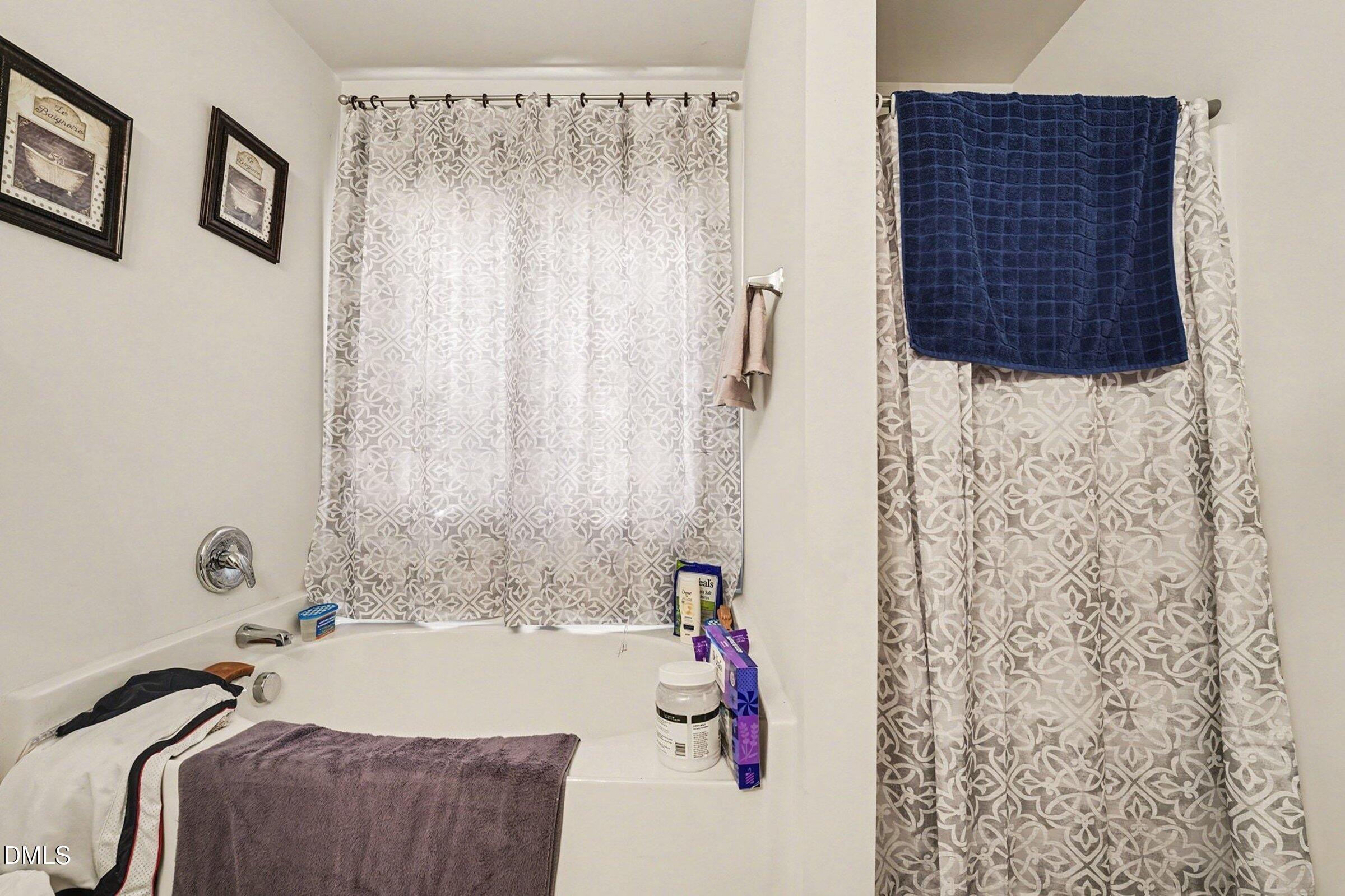 1404 Ricochet Drive Raleigh, NC 27610 - Photo 18 of 31 a bathroom with a bathtub and shower