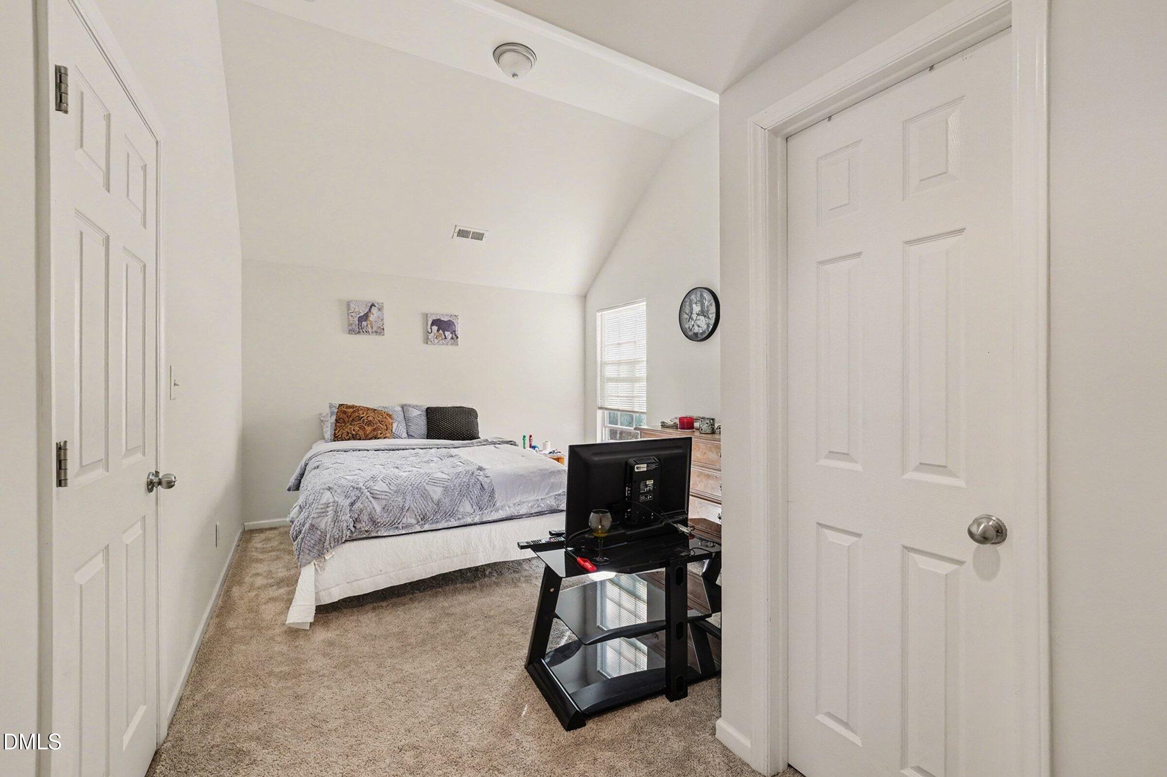 1404 Ricochet Drive Raleigh, NC 27610 - Photo 19 of 31 a bedroom with a bed and a window