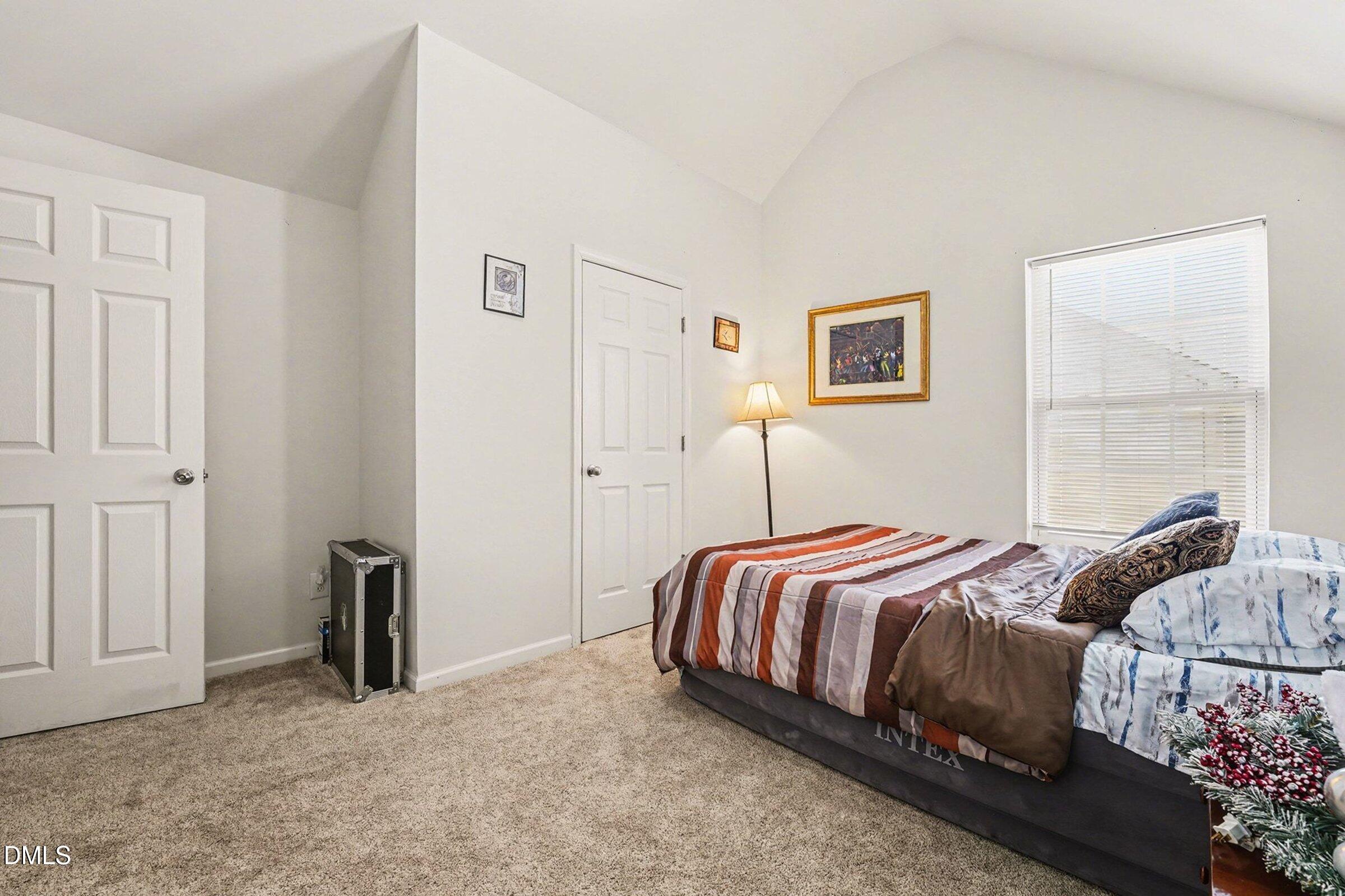 1404 Ricochet Drive Raleigh, NC 27610 - Photo 21 of 31 a bedroom with a bed and a window