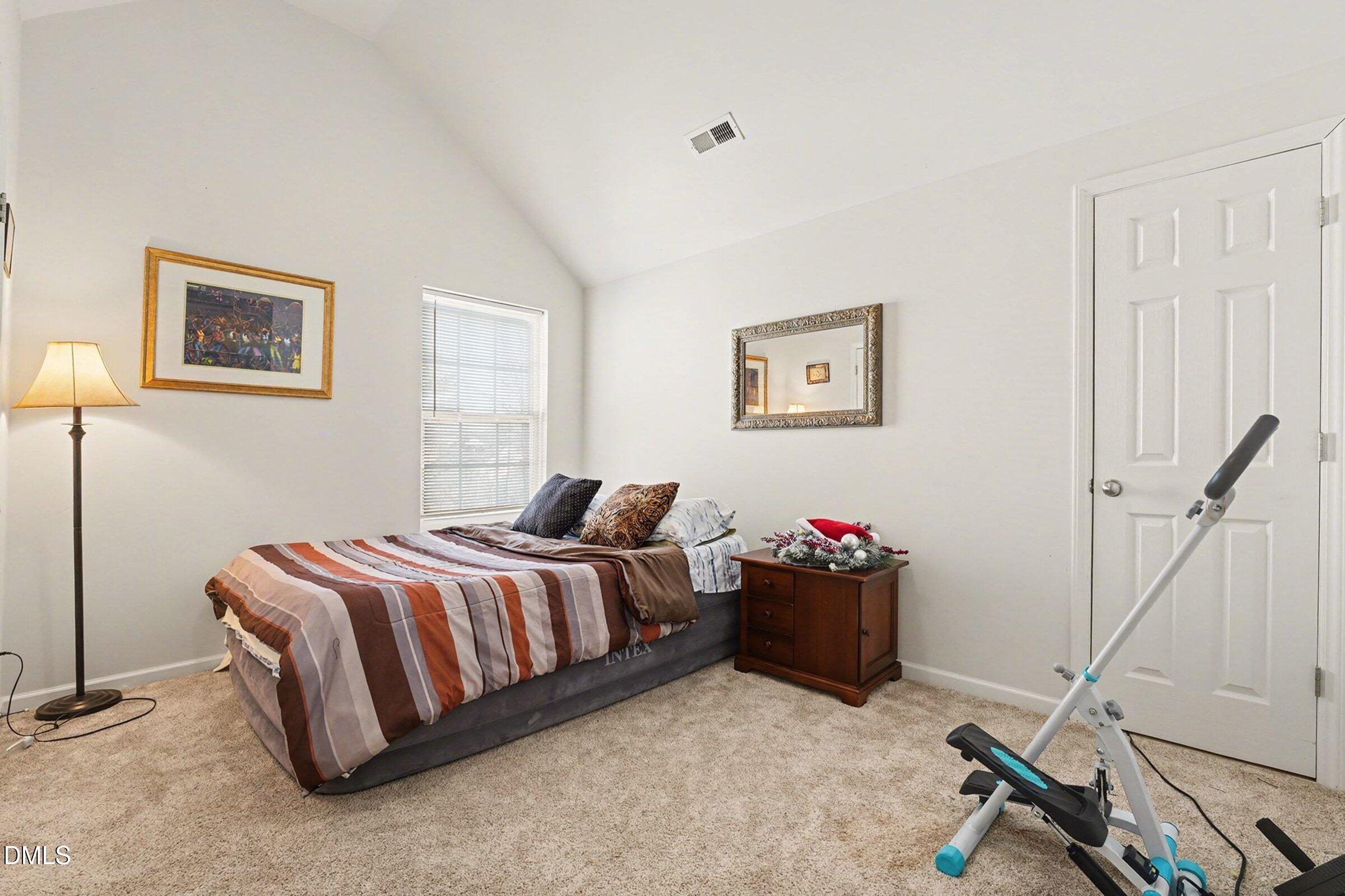 1404 Ricochet Drive Raleigh, NC 27610 - Photo 22 of 31 a bedroom with a bed and cabinets