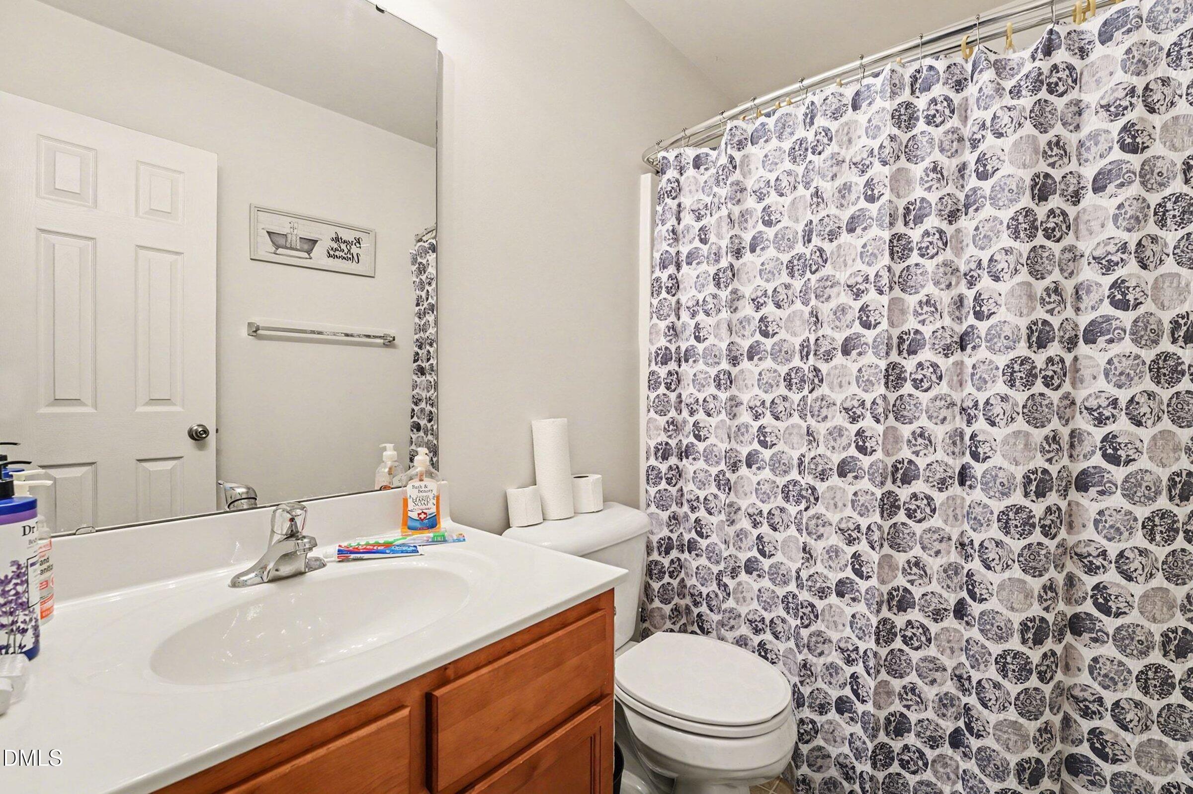 1404 Ricochet Drive Raleigh, NC 27610 - Photo 23 of 31 a bathroom with a sink toilet and shower