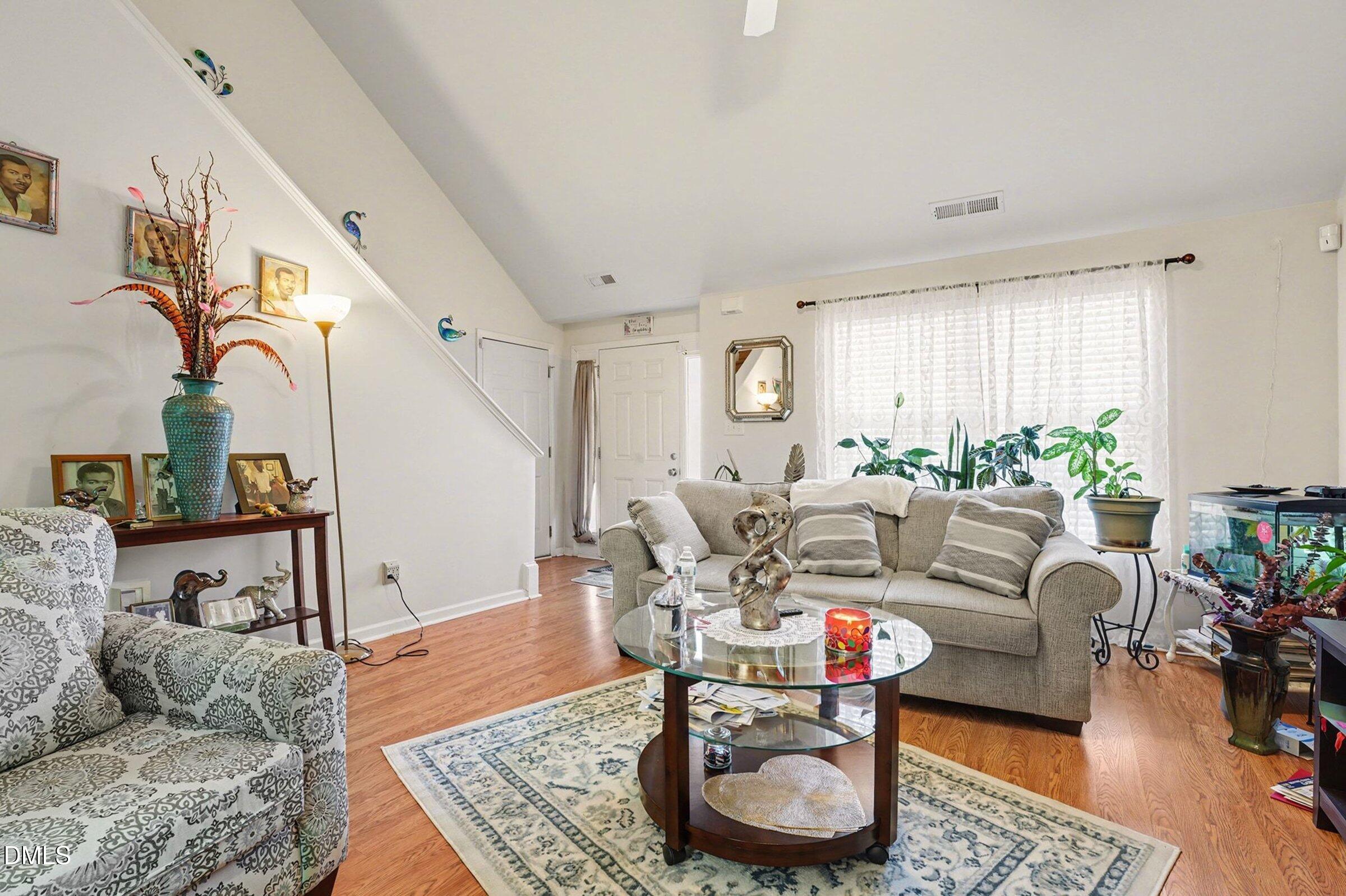 1404 Ricochet Drive Raleigh, NC 27610 - Photo 8 of 31 a living room with furniture and a potted plant