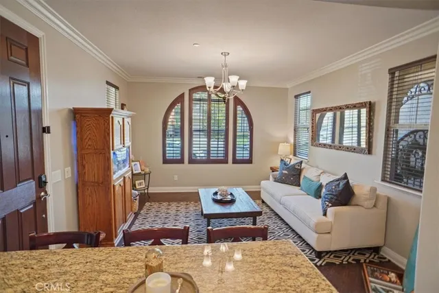 a kitchen with kitchen island granite countertop a stove a sink a refrigerator dining table and chairs