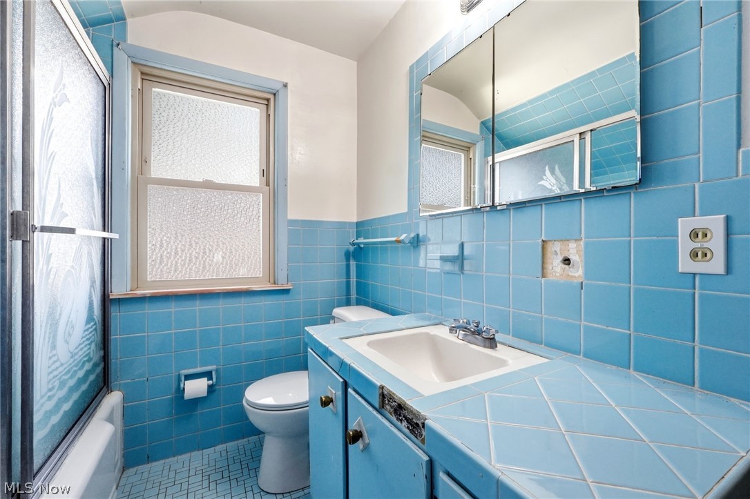 2537 Edgewood Road Beachwood, OH 44122 - Photo 31 of 39 Bathroom featuring blue square wall tiles and a matching tiled vanity countertop