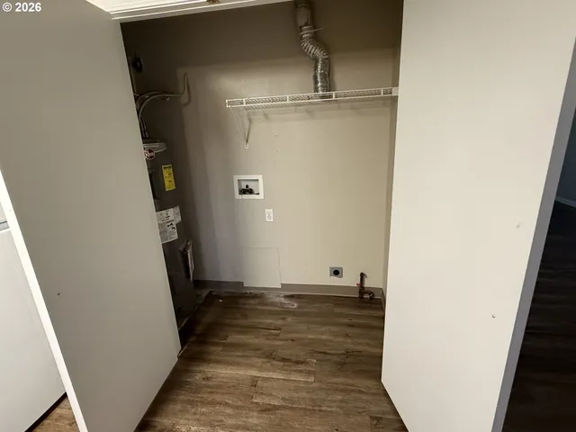 a view of a room with wooden floor