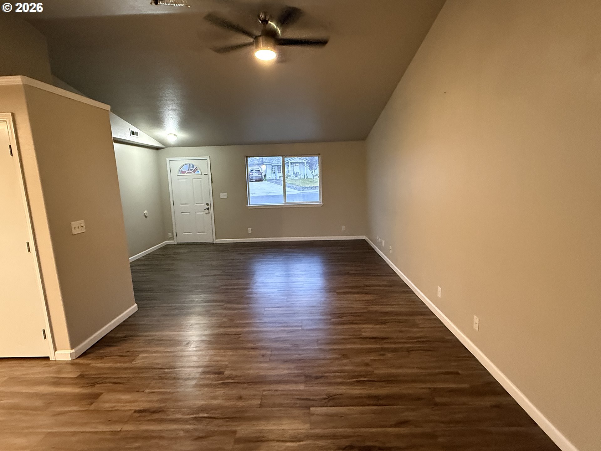 70 Northeast Alora Drive Hermiston, OR 97838 - Photo 6 of 14 an empty room with wooden floor and windows