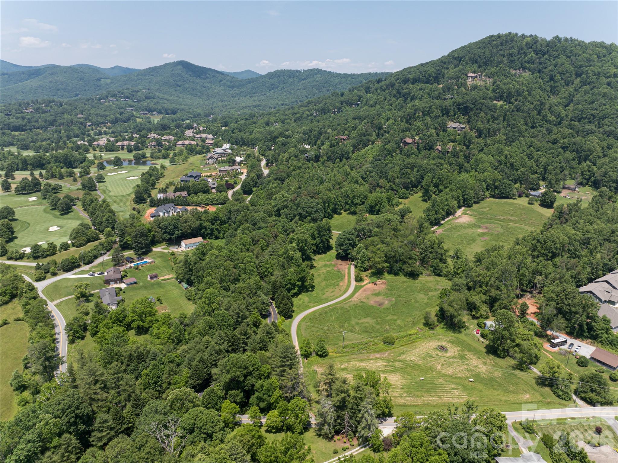 173 Avery Creek Road Arden, NC 28704 - Photo 19 of 35 a view of a lush green hillside and houses