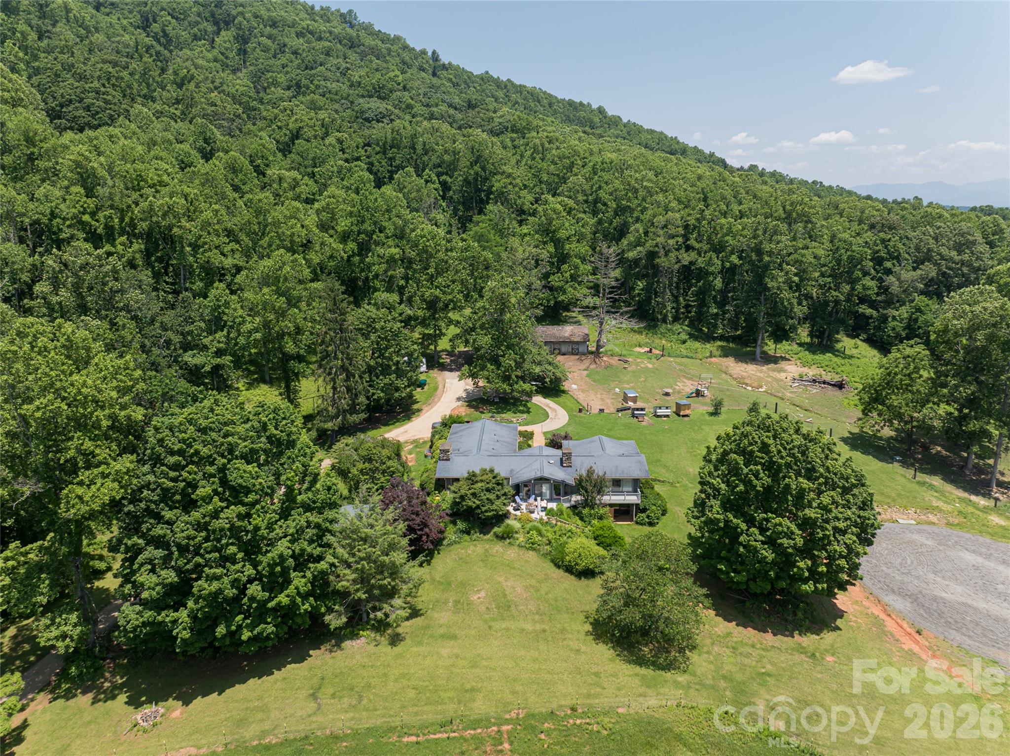 173 Avery Creek Road Arden, NC 28704 - Photo 24 of 35 a view of a garden with lawn chairs
