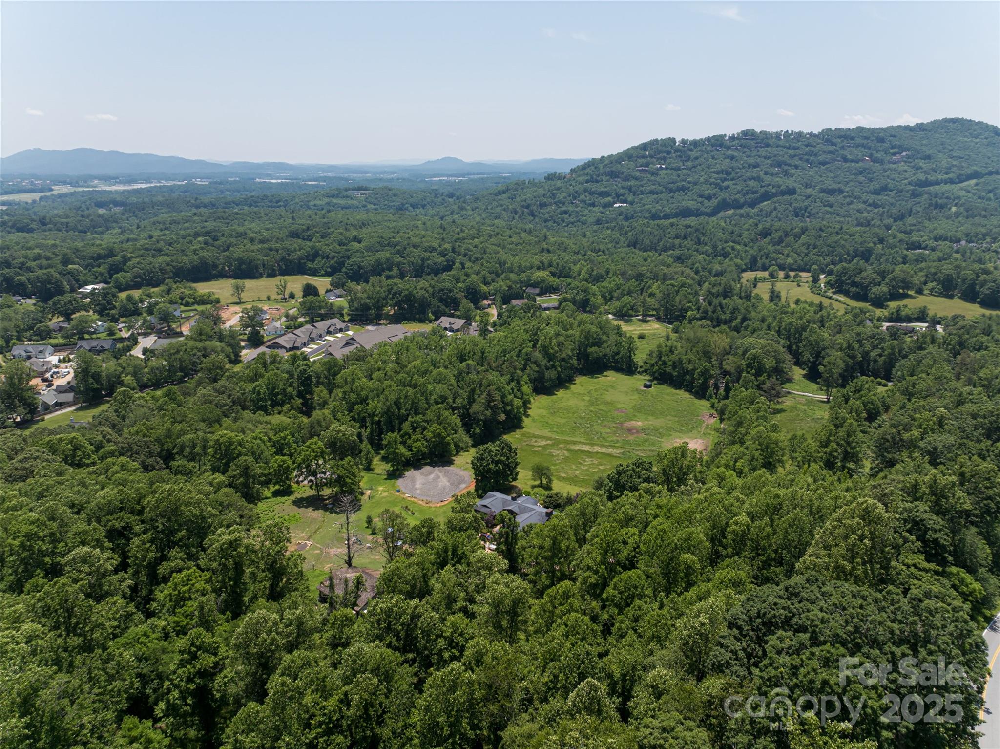 173 Avery Creek Road Arden, NC 28704 - Photo 30 of 35 an aerial view of a houses with a lush green hillside