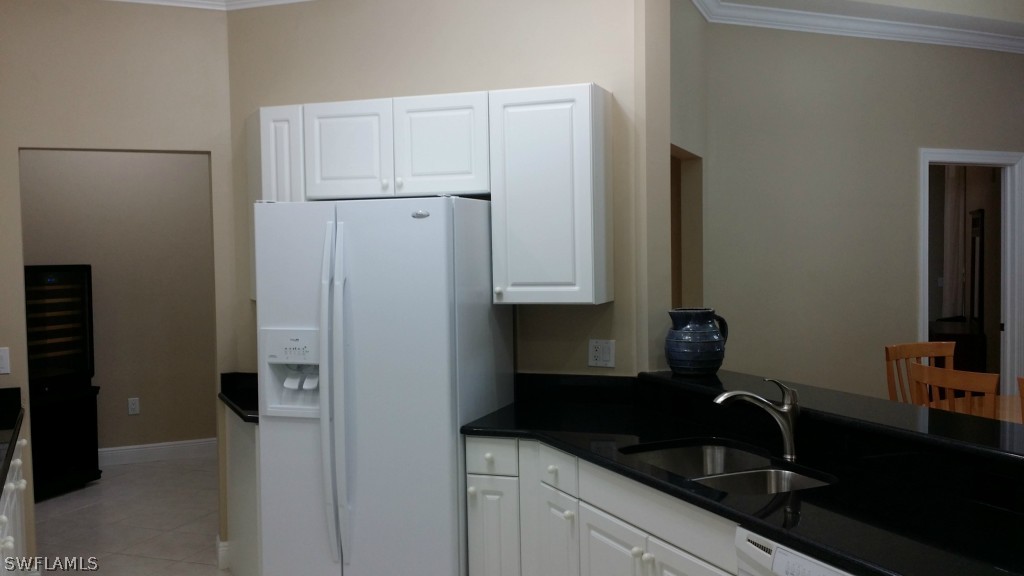 2743 First Street, Unit 305 Fort Myers, FL 33916 - Photo 10 of 21 a kitchen with a sink and refrigerator