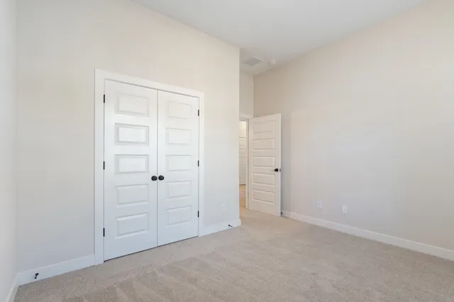 an empty room with closet area