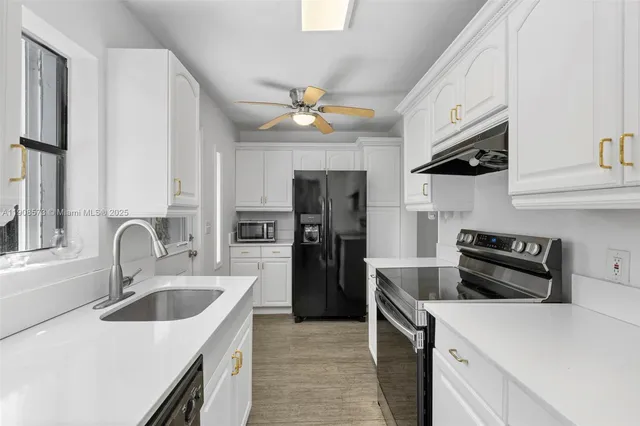 a kitchen with a refrigerator sink and stove