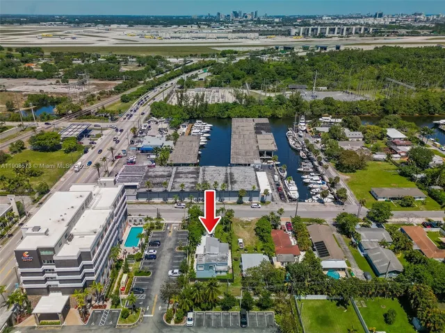 an aerial view of a houses with a swimming pool