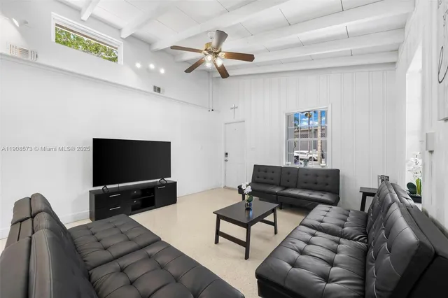 a living room with furniture and a flat screen tv