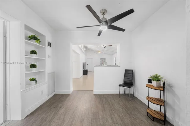 a view of a workspace with furniture and wooden floor