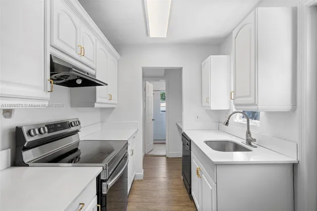 a kitchen that has a sink and a stove