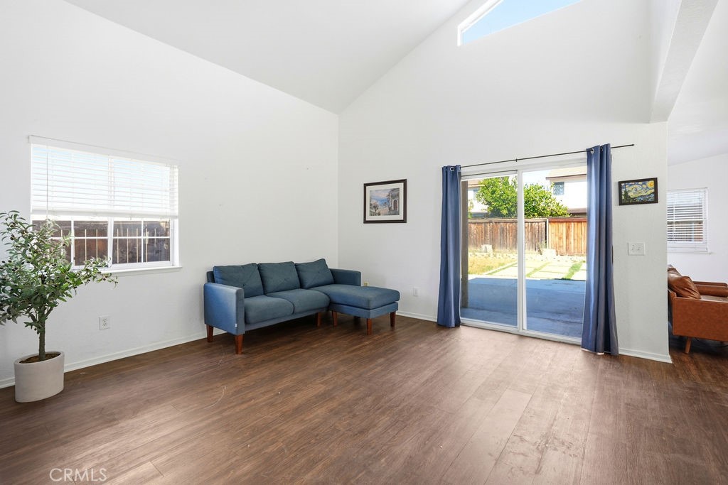 a living room with furniture and potted plants