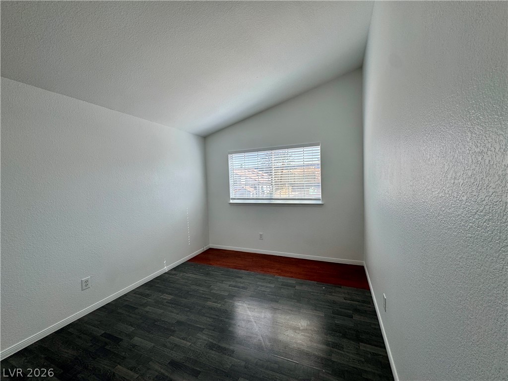 73 Sea Holly Way Henderson, NV 89074 - Photo 52 of 59 Spare room featuring a textured wall and dark wood-style flooring