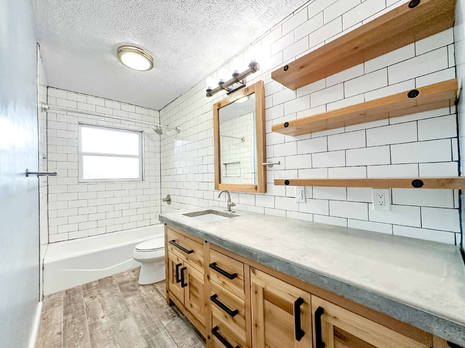 2608 Raleigh Avenue Lubbock, TX 79410 - Photo 13 of 23 a bathroom with a granite countertop sink and a bathtub