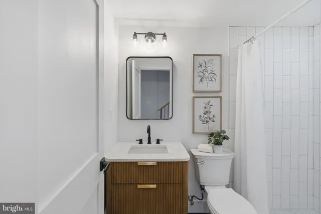 a bathroom with a toilet sink and mirror