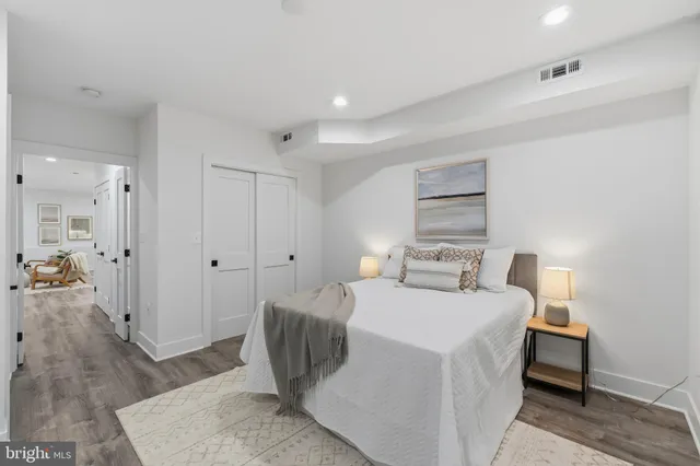 a room with a bed and a view of living room