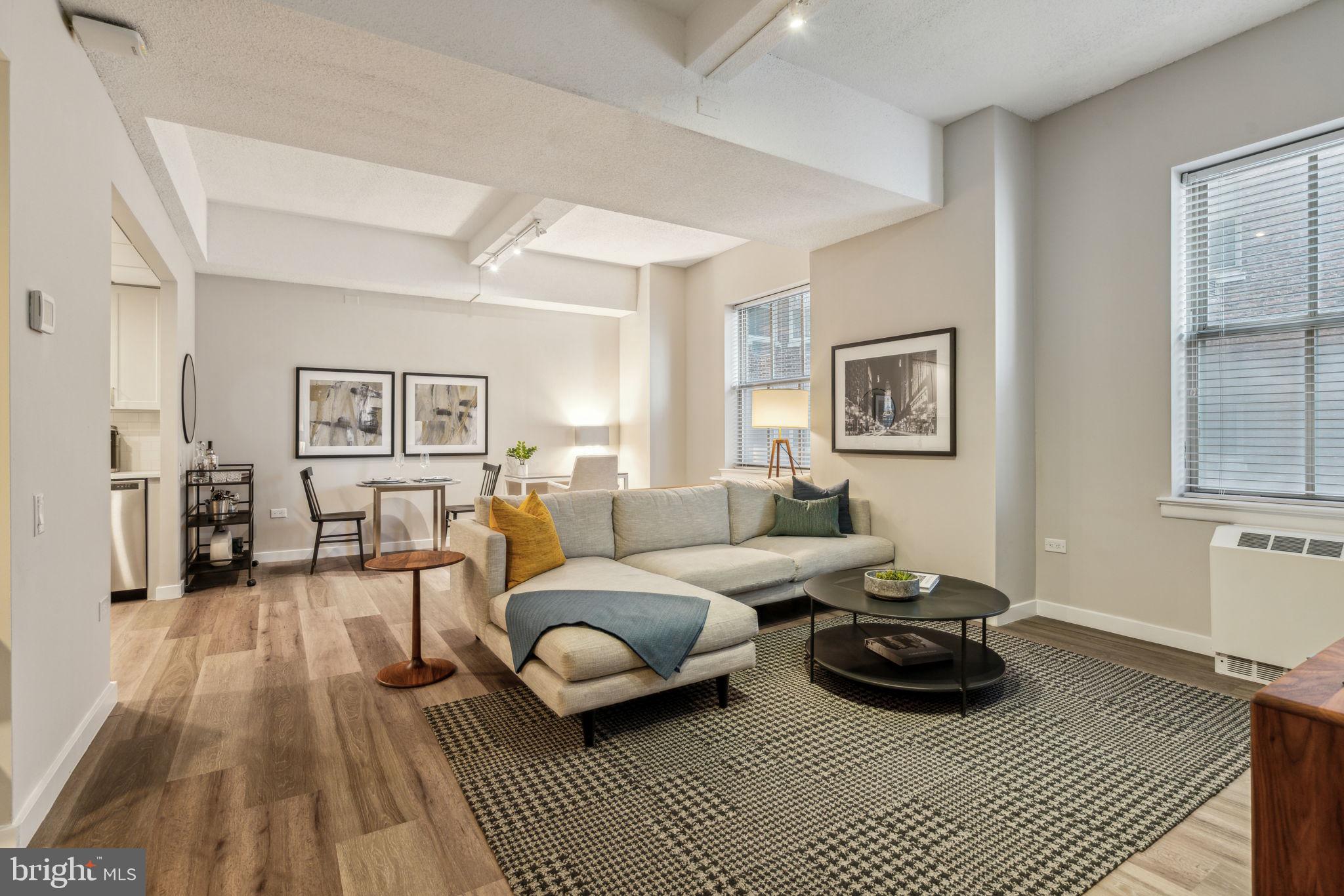 875 Sansom Street, Unit 1013 Philadelphia, PA 19107 - Photo 5 of 34 a living room with furniture a rug and a window