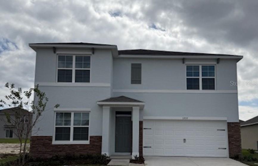 5259 Nickerbean Street Apopka, FL 32712 - Photo 1 of 33 a front view of a house with a yard
