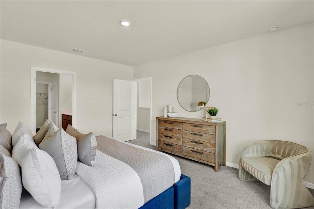 5259 Nickerbean Street Apopka, FL 32712 - Photo 21 of 33 a bedroom with a bed and furniture