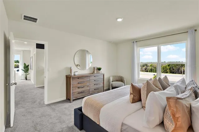 a bedroom with a bed and a dresser