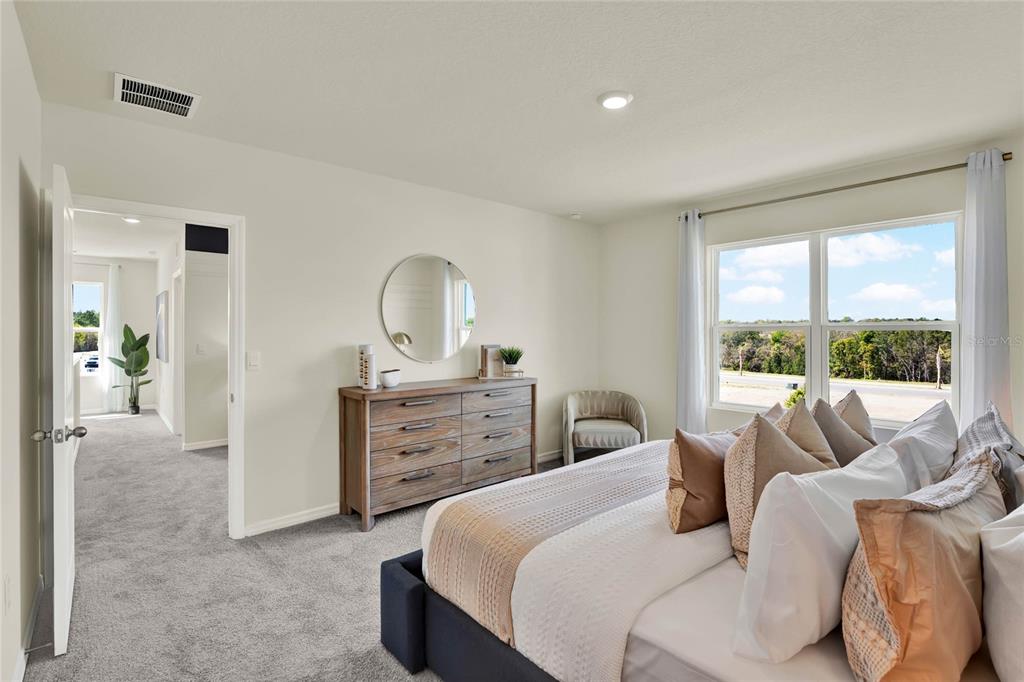 5259 Nickerbean Street Apopka, FL 32712 - Photo 22 of 33 a bedroom with a bed and a dresser