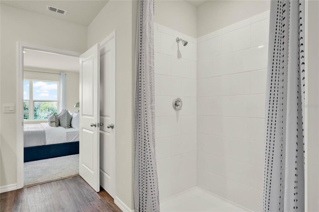 5259 Nickerbean Street Apopka, FL 32712 - Photo 24 of 33 a bathroom with a bathtub and a shower