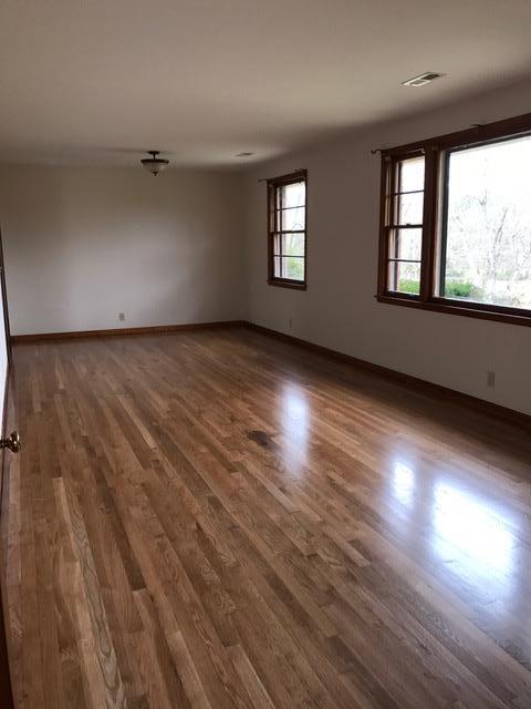 1226 Center Point Road Hendersonville, TN 37075 - Photo 6 of 14 an empty room with wooden floor and windows