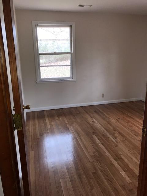 1226 Center Point Road Hendersonville, TN 37075 - Photo 10 of 14 an empty room with wooden floor and windows