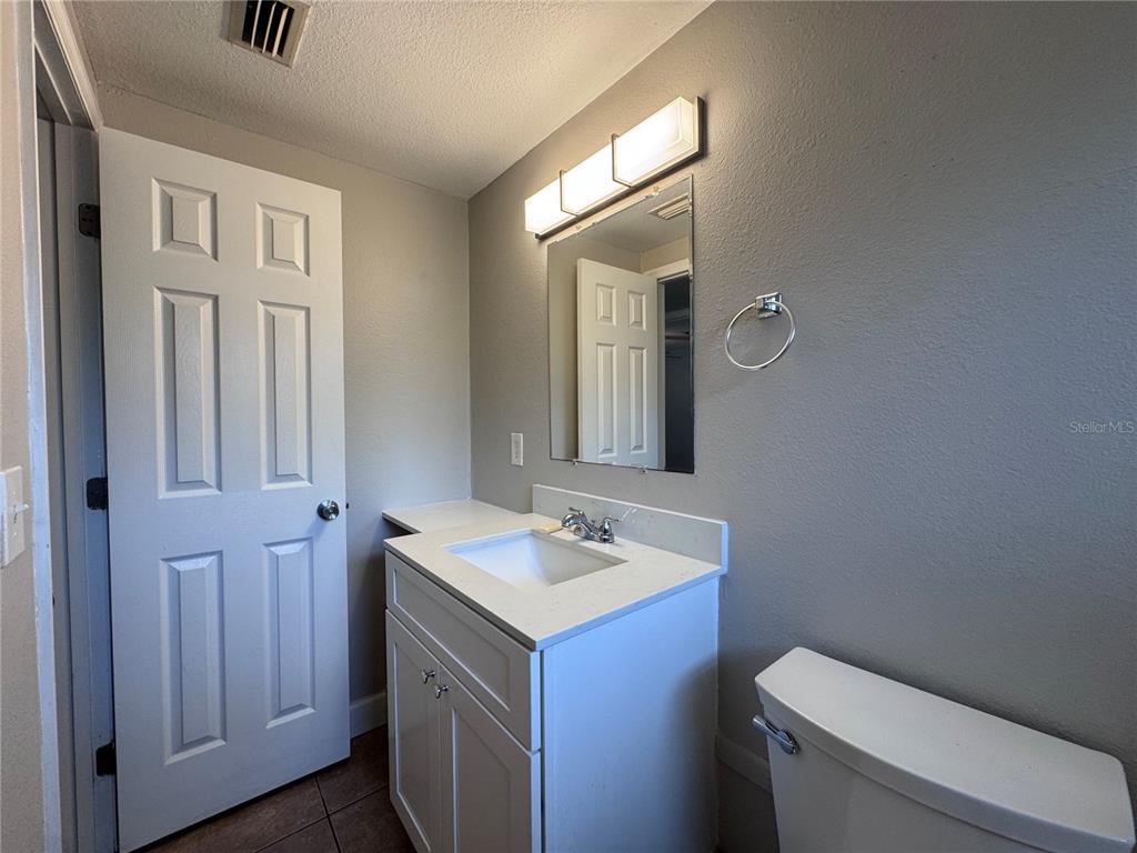 514 Winham Street Tampa, FL 33619 - Photo 9 of 15 a bathroom with a sink toilet and vanity