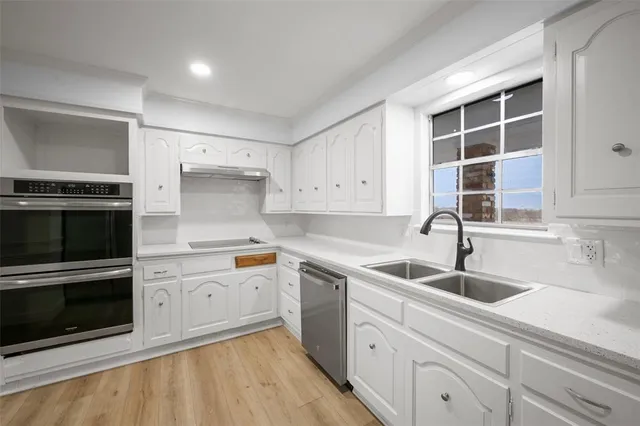 a kitchen with a sink stove and cabinets