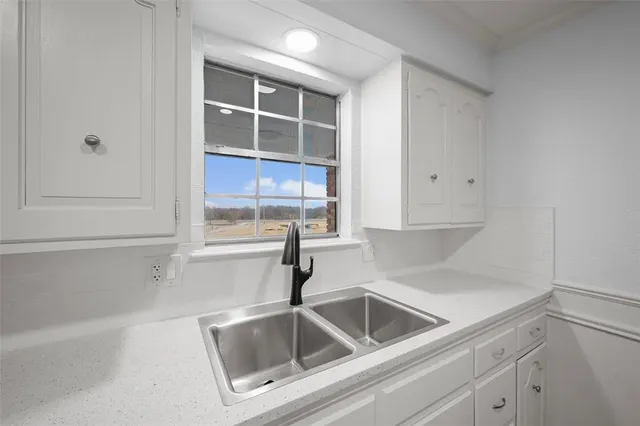 a kitchen with a sink and cabinets