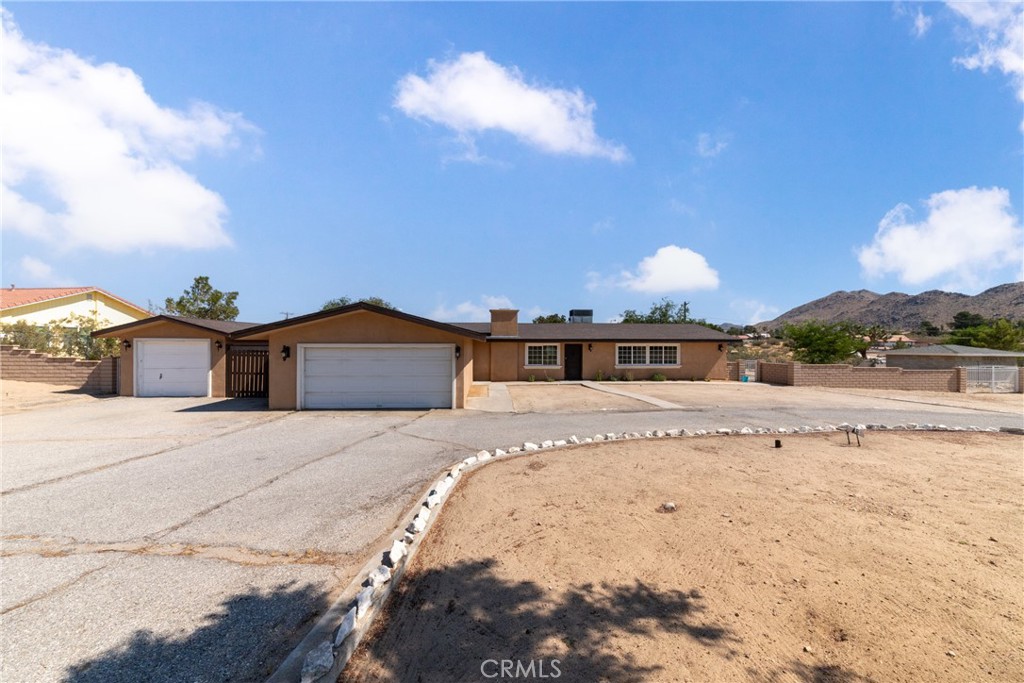 19168 Lenca Road Apple Valley, CA 92307 - Photo 1 of 1 a view of a house with a snow in the background