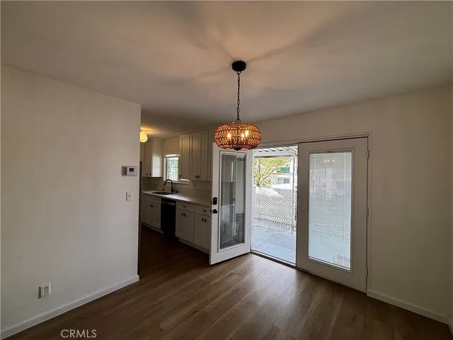 a kitchen with stainless steel appliances granite countertop cabinets and wooden floor
