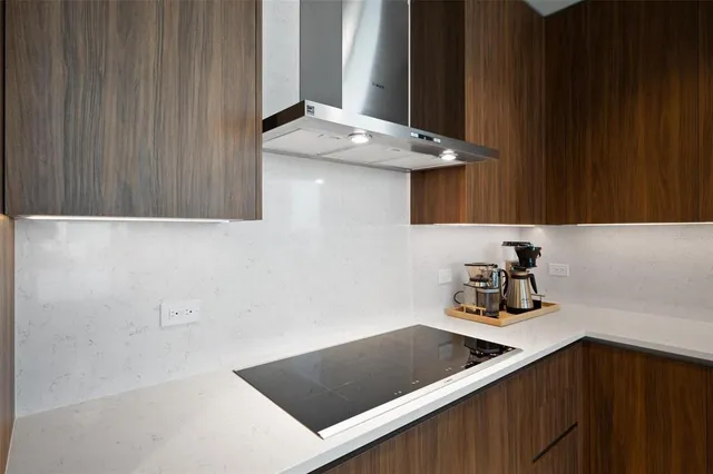 a living room with furniture potted plant floor to ceiling windows and a table