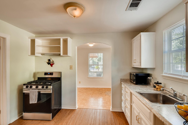 711 Jewell Street, Unit A & B Austin, TX 78704 - Photo 12 of 17 a kitchen with granite countertop a stove and a sink