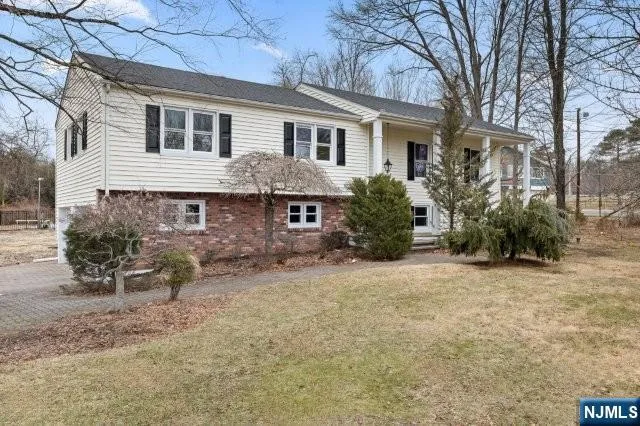 a front view of a house with a yard covered with snow