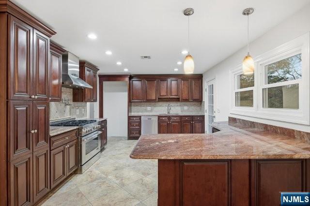 373 West Saddle River Road Upper Saddle River, NJ 07458 - Photo 13 of 31 a kitchen with granite countertop kitchen island stainless steel appliances a sink stove and refrigerator