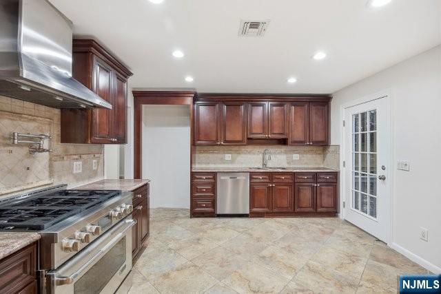 373 West Saddle River Road Upper Saddle River, NJ 07458 - Photo 15 of 31 a kitchen with stainless steel appliances granite countertop a stove top oven a sink and dishwasher