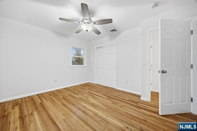373 West Saddle River Road Upper Saddle River, NJ 07458 - Photo 22 of 31 an empty room with wooden floor fan and windows