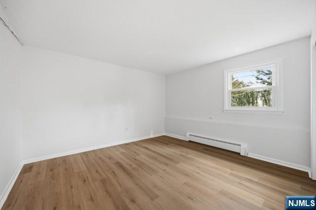 373 West Saddle River Road Upper Saddle River, NJ 07458 - Photo 27 of 31 an empty room with wooden floor and windows