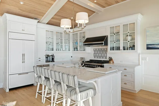 a kitchen with stainless steel appliances granite countertop a stove and a refrigerator