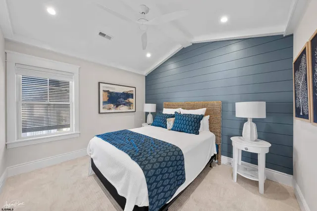 a bathroom with a double vanity sink a large mirror and a bathtub