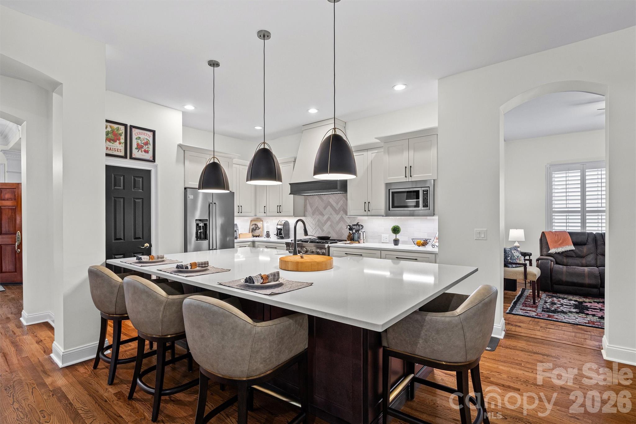 2578 Lower Assembly Drive Fort Mill, SC 29708 - Photo 4 of 28 a kitchen with a dining table chairs and white cabinets